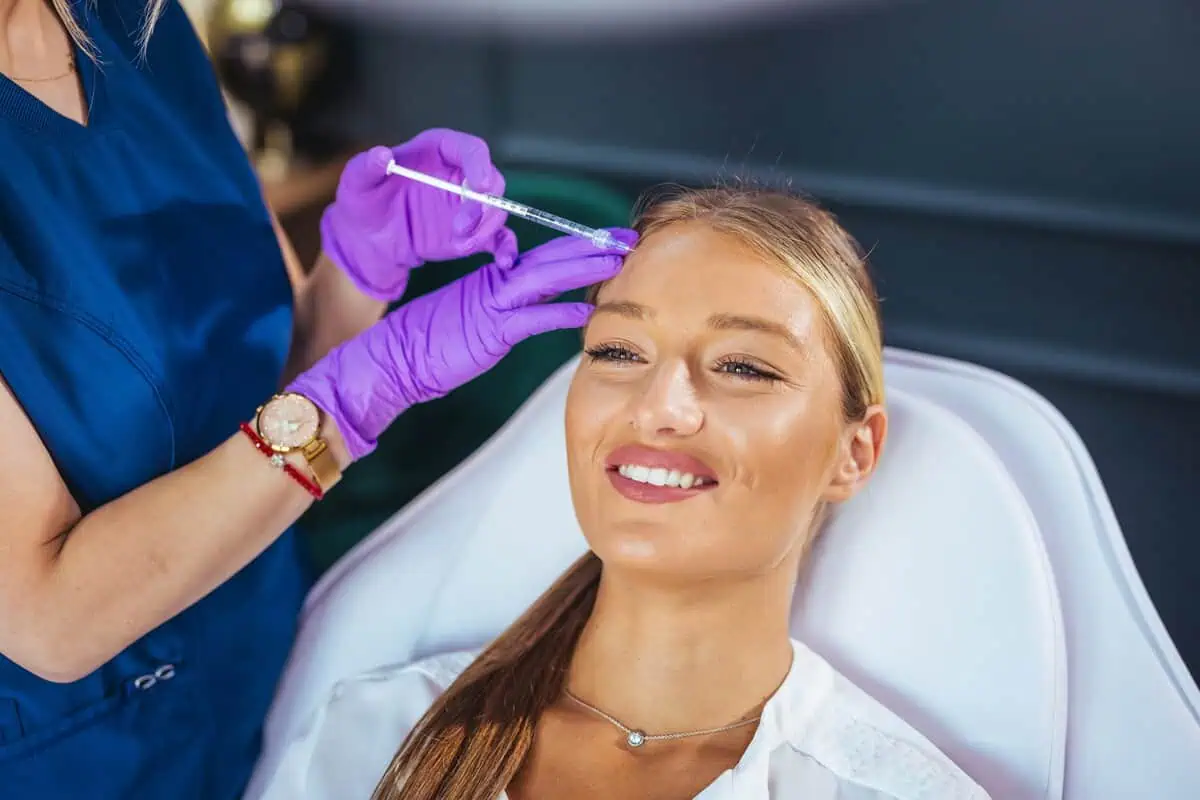 A woman receiving a cosmetic injectable treatment during her first appointment at Divine Age Med Spa in Wesley Chapel, FL.